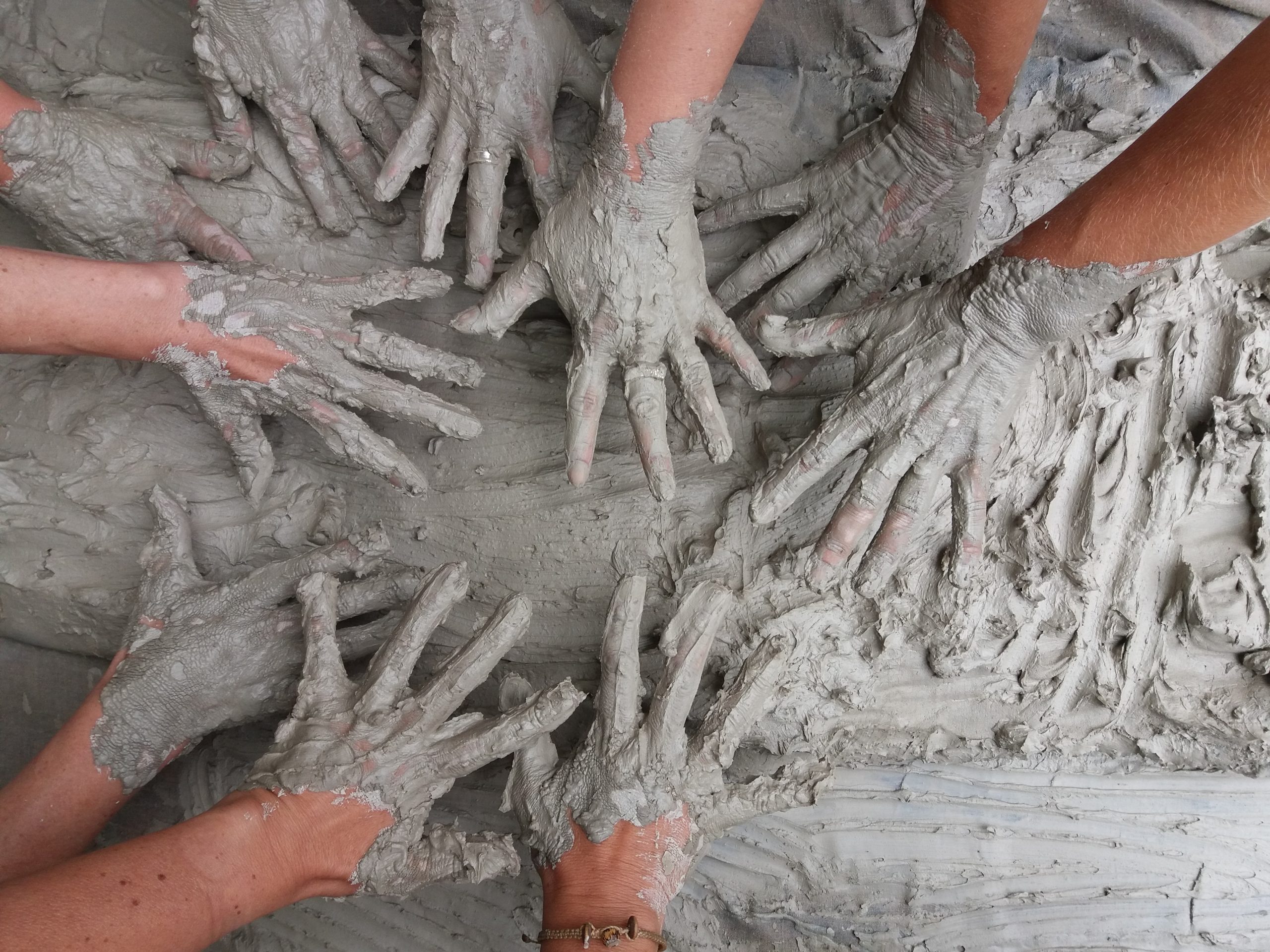 Hands Covered in Clay During a Class