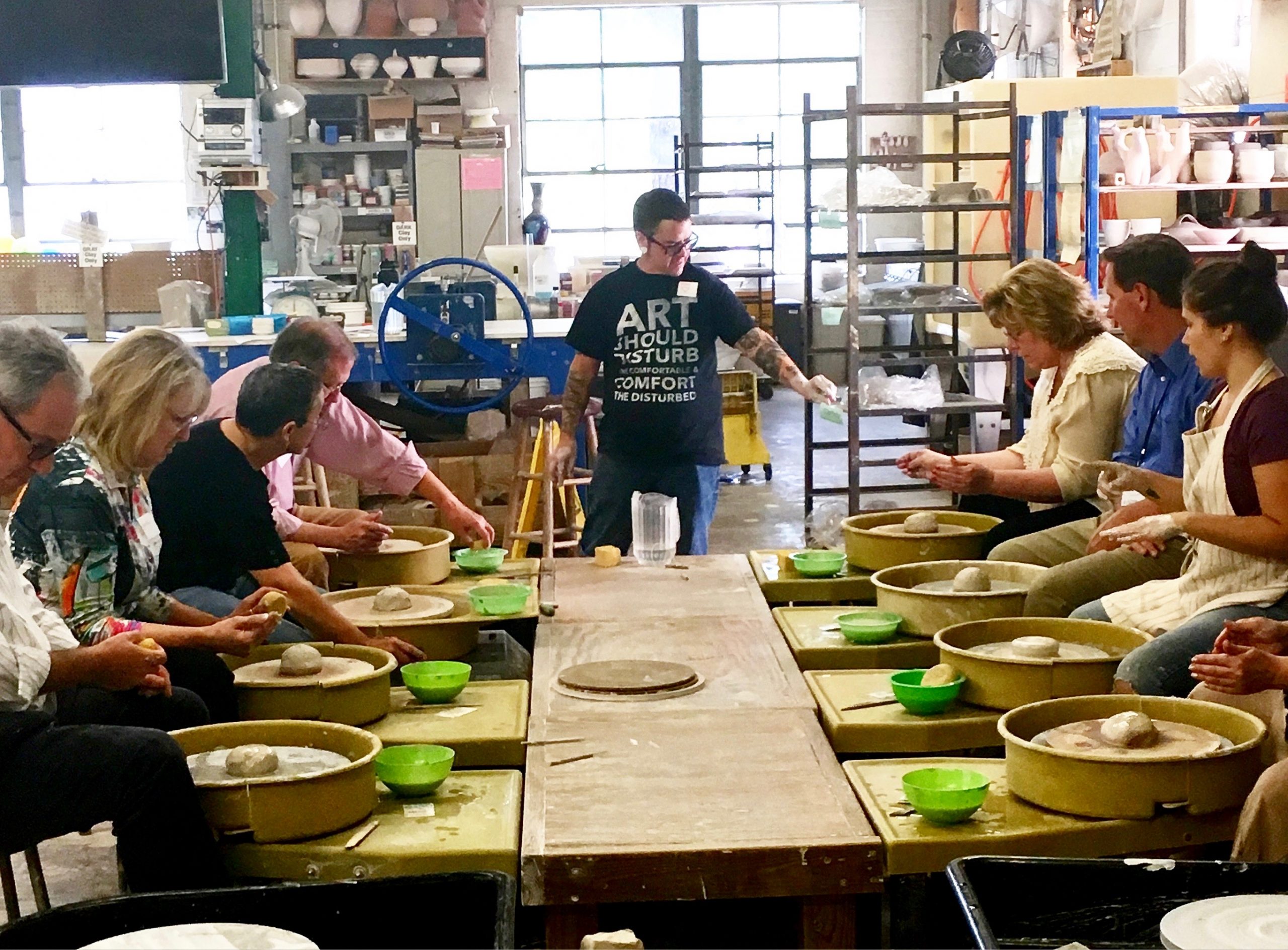 Large Group Pottery Wheel Class Being Explained